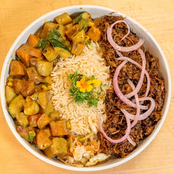 Manjay Restaurant's Caribbean bowl with curried vegetables, rice, pulled pork, and pickled onions.